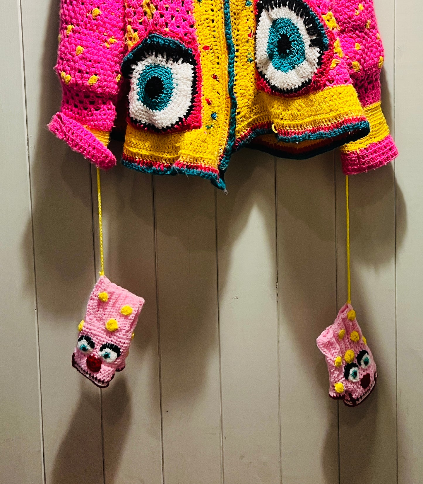 Mr Blobby themed crocheted gloves on a string