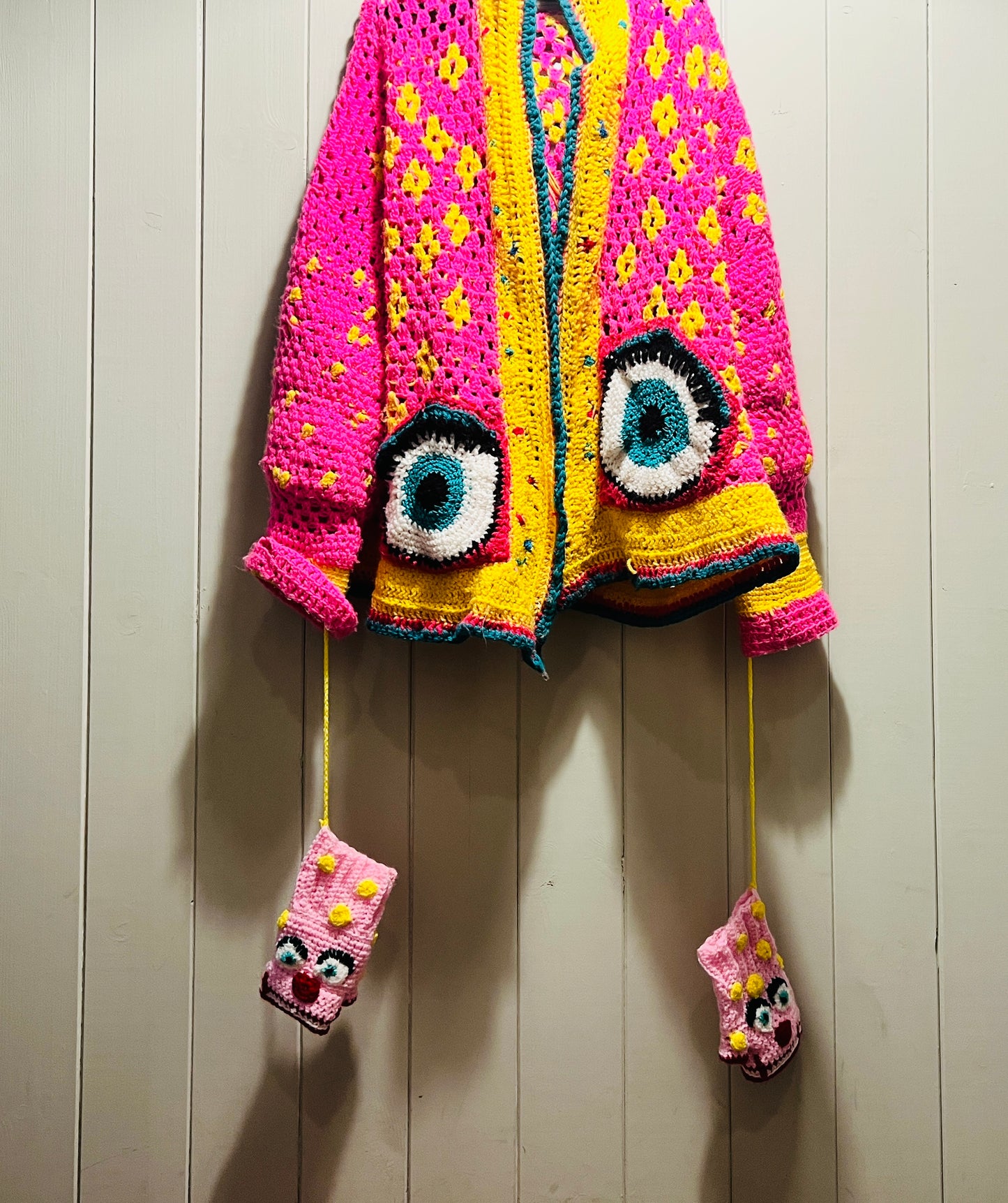 Mr Blobby themed crocheted gloves on a string