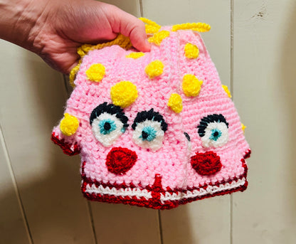 Mr Blobby themed crocheted gloves on a string