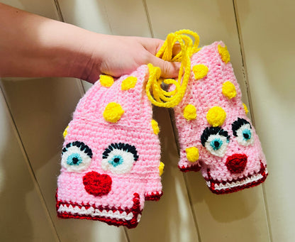 Mr Blobby themed crocheted gloves on a string