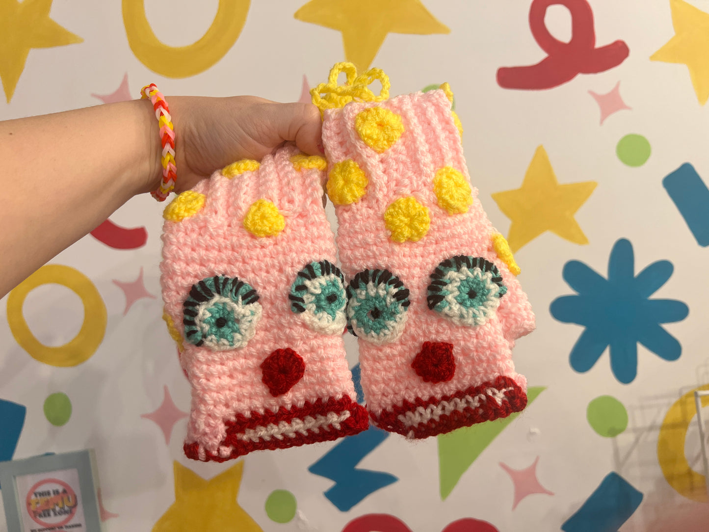 Mr Blobby themed crocheted gloves on a string