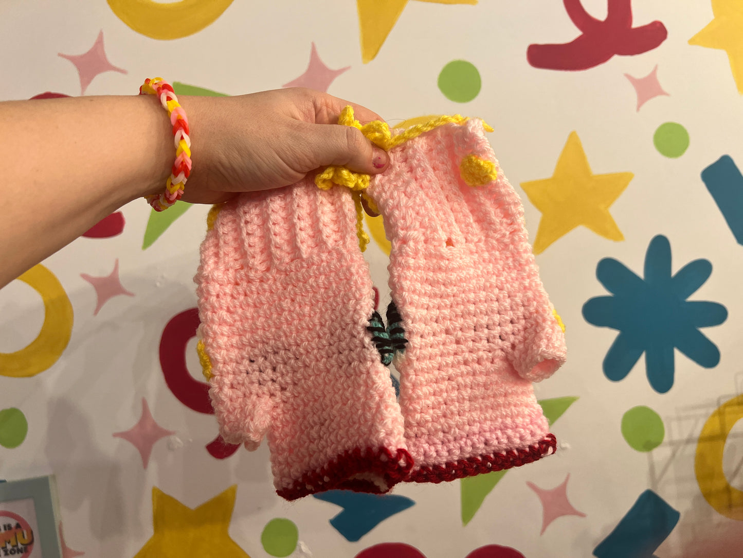 Mr Blobby themed crocheted gloves on a string