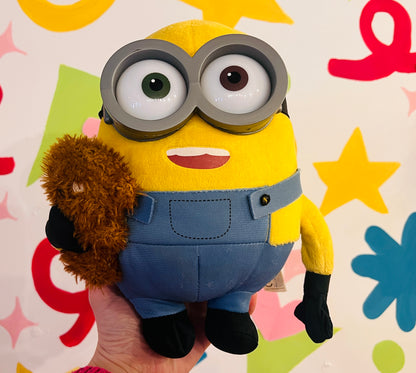 Minions plush toy holding teddy